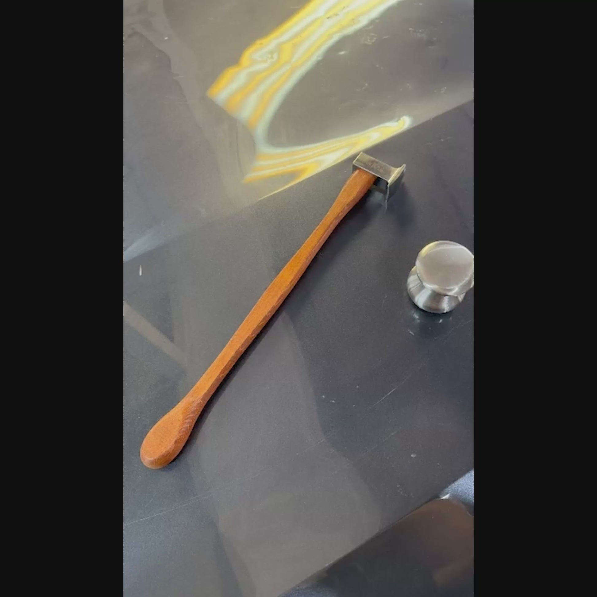 Ergonomic magnetic wooden handle of the PDR Uzbek blending hammer holding a metal knockdown pointer tool during professional auto body repair.