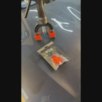 PDR INOX Sergio Pillon square tabs applied to a vehicle dent