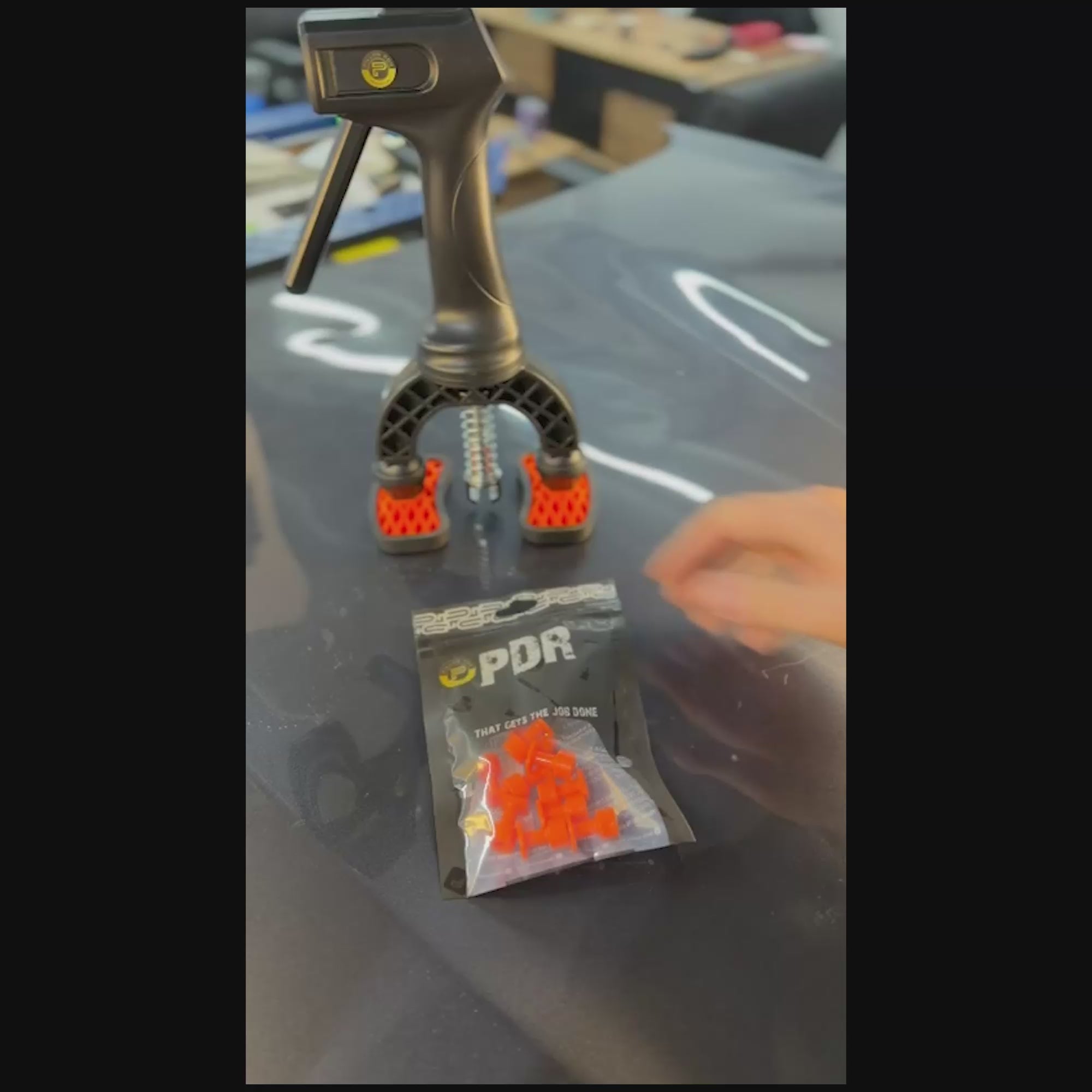 PDR INOX 12x12mm square tab applied to a pinpoint dent