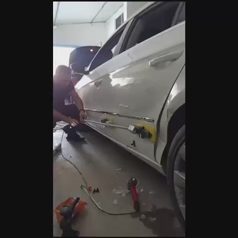 Technician using the articulated head kit for PDR
