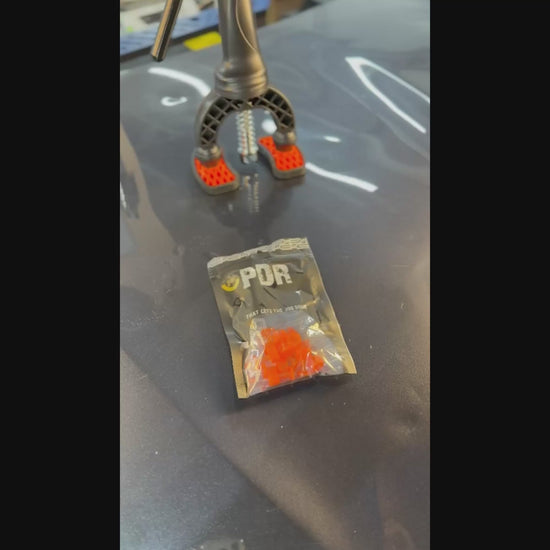 PDR INOX transparent round tab positioned on a small hail dent