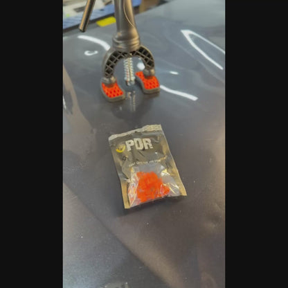 PDR INOX transparent round tab positioned on a small hail dent